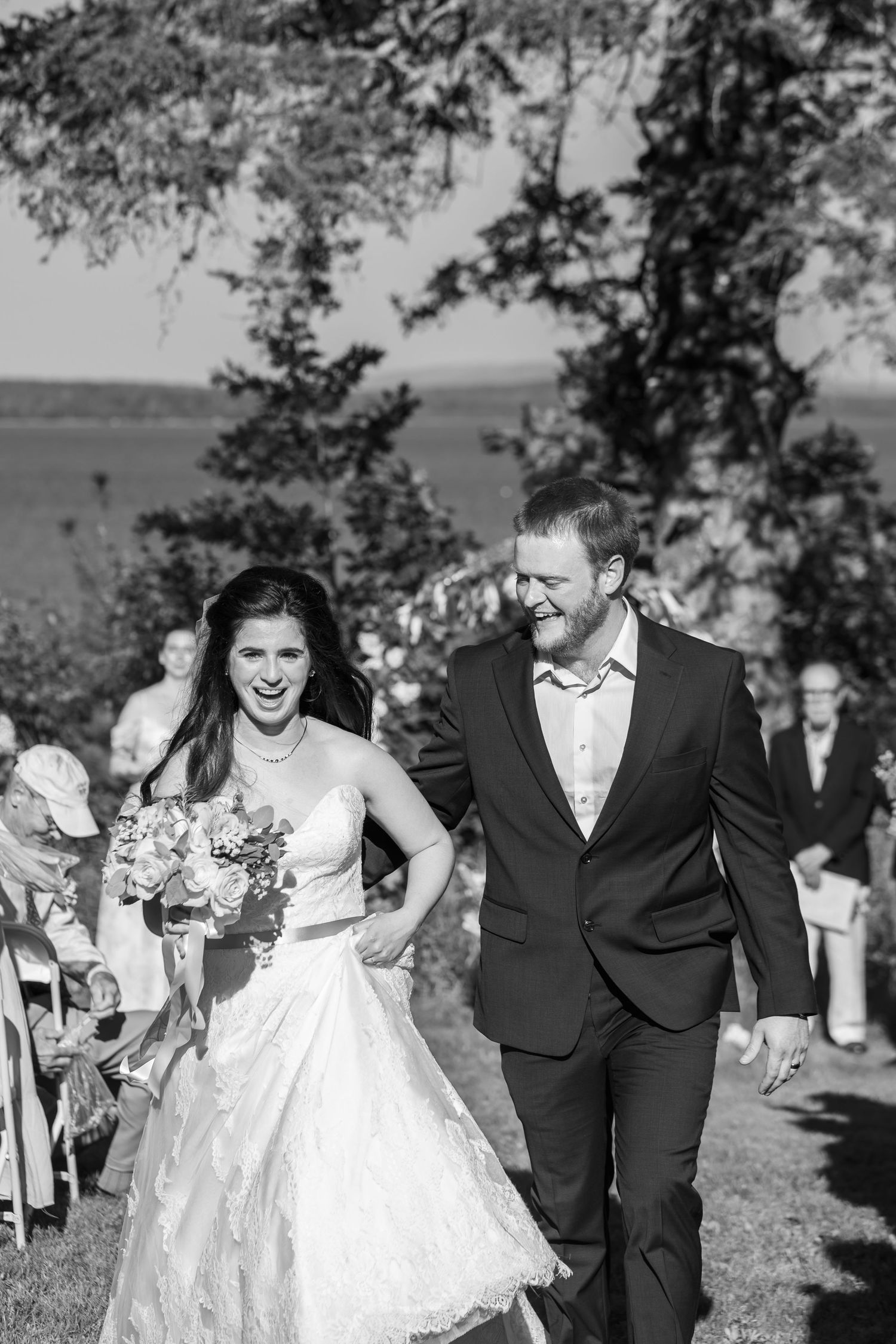 Bride and laughing as they walk down the aisle at a backyard wedding in Brooklin, Maine