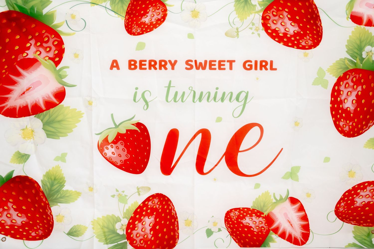 Decorative banner with strawberry pattern and text design.