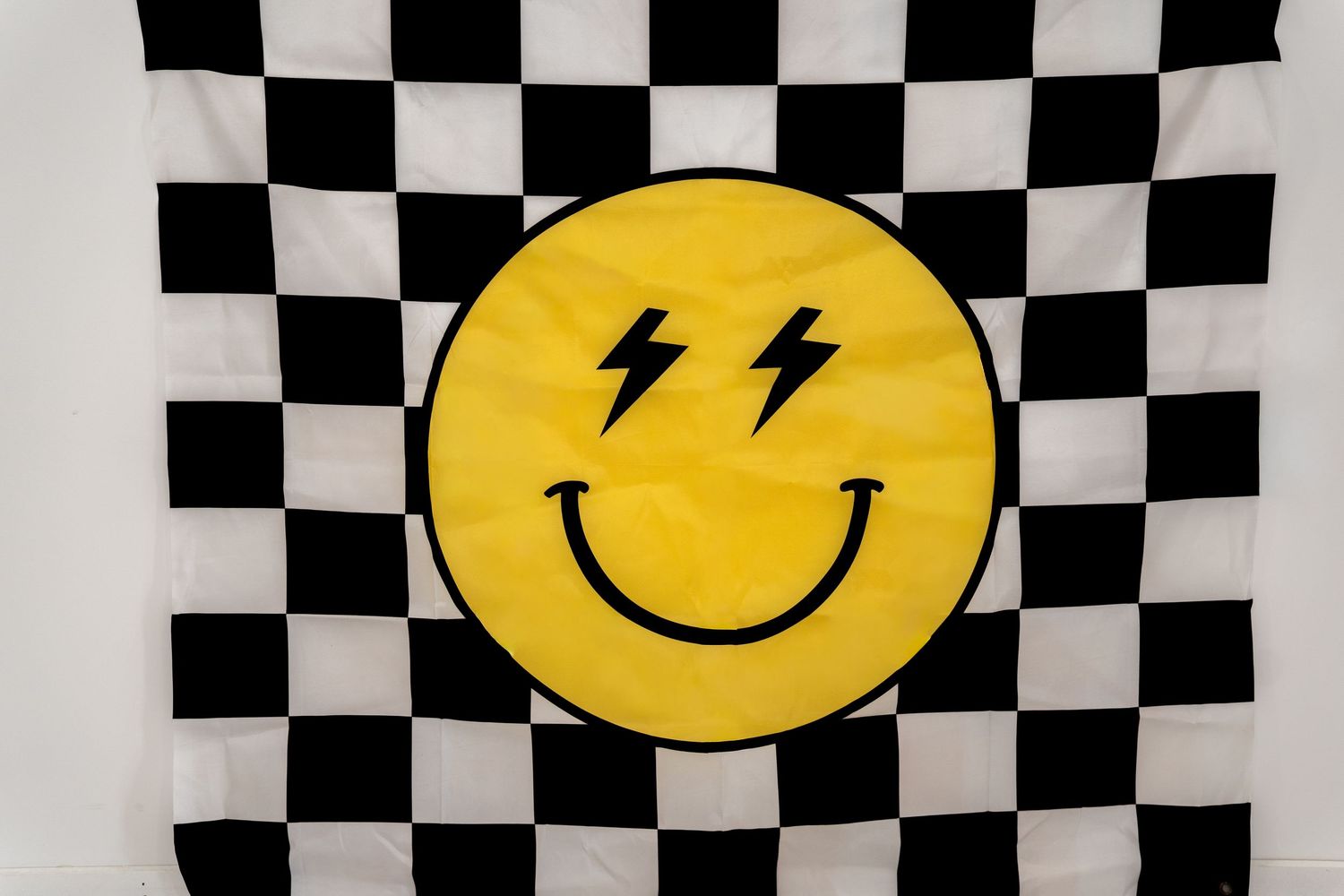 Checkered pattern background with yellow smiley face designs.