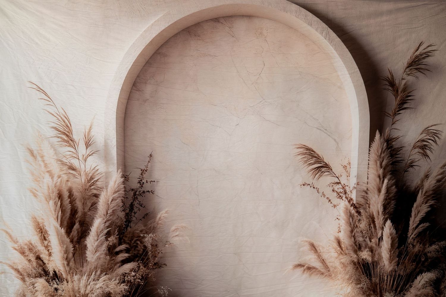 Minimalist arch background with dried pampas grass creating an elegant neutral tone setting.