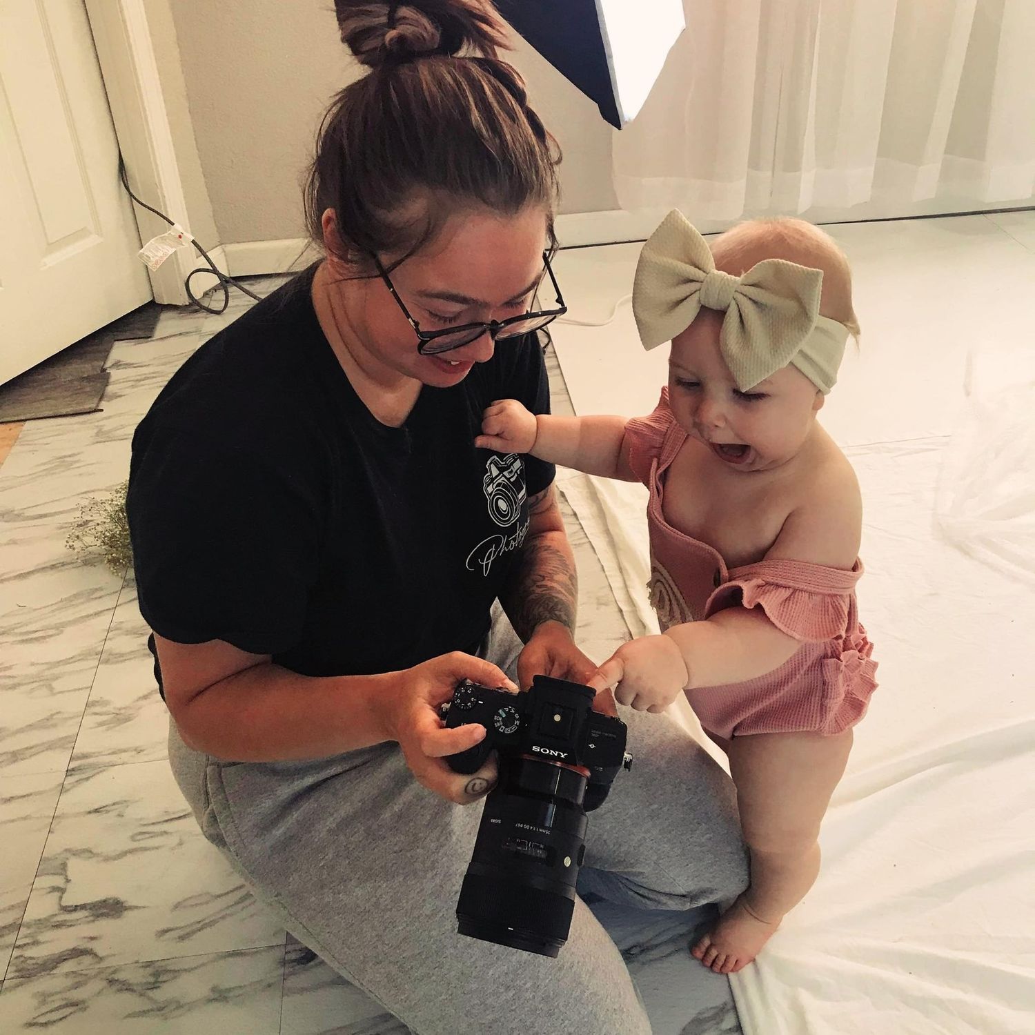 Photography session behind the scenes showing camera equipment and setup.