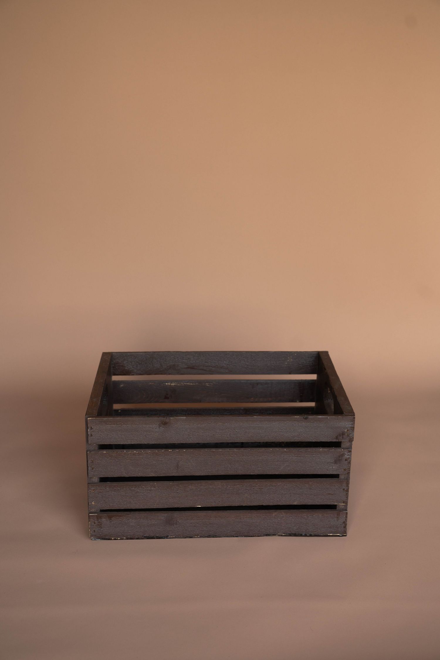 Rustic wooden crate shown from multiple angles against beige background.