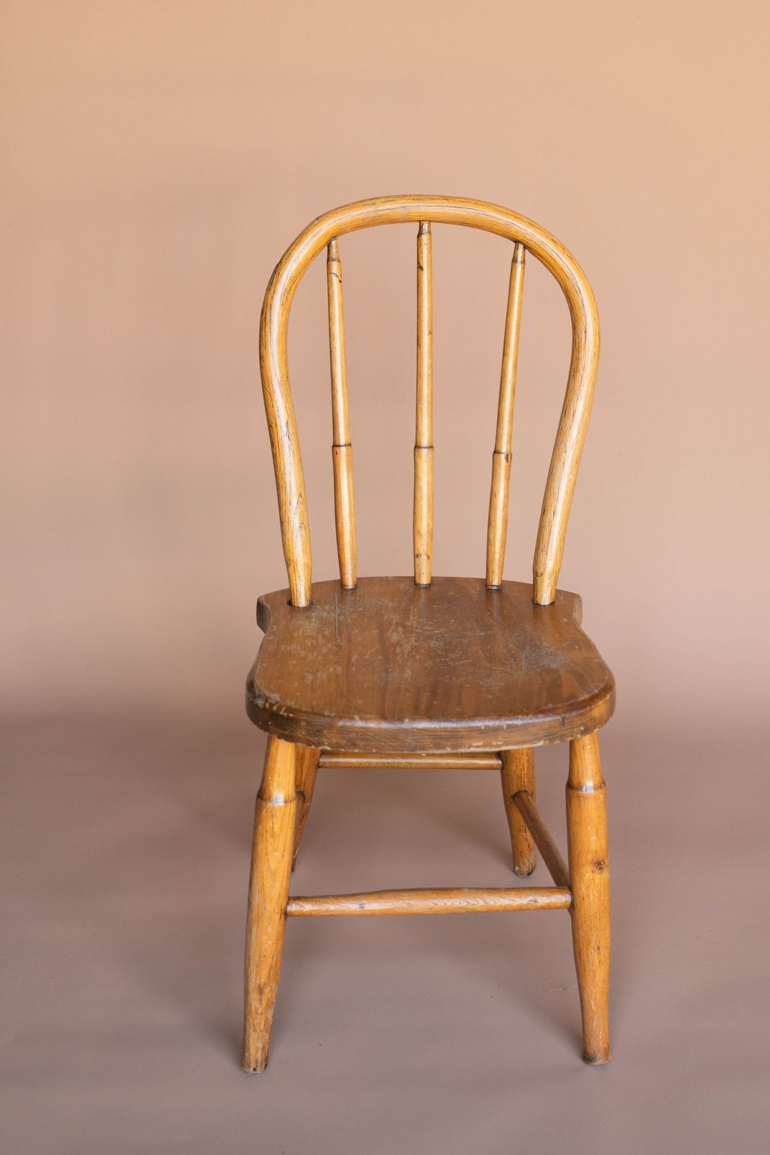 Vintage wooden child's bench seat shown from different angles on neutral background.