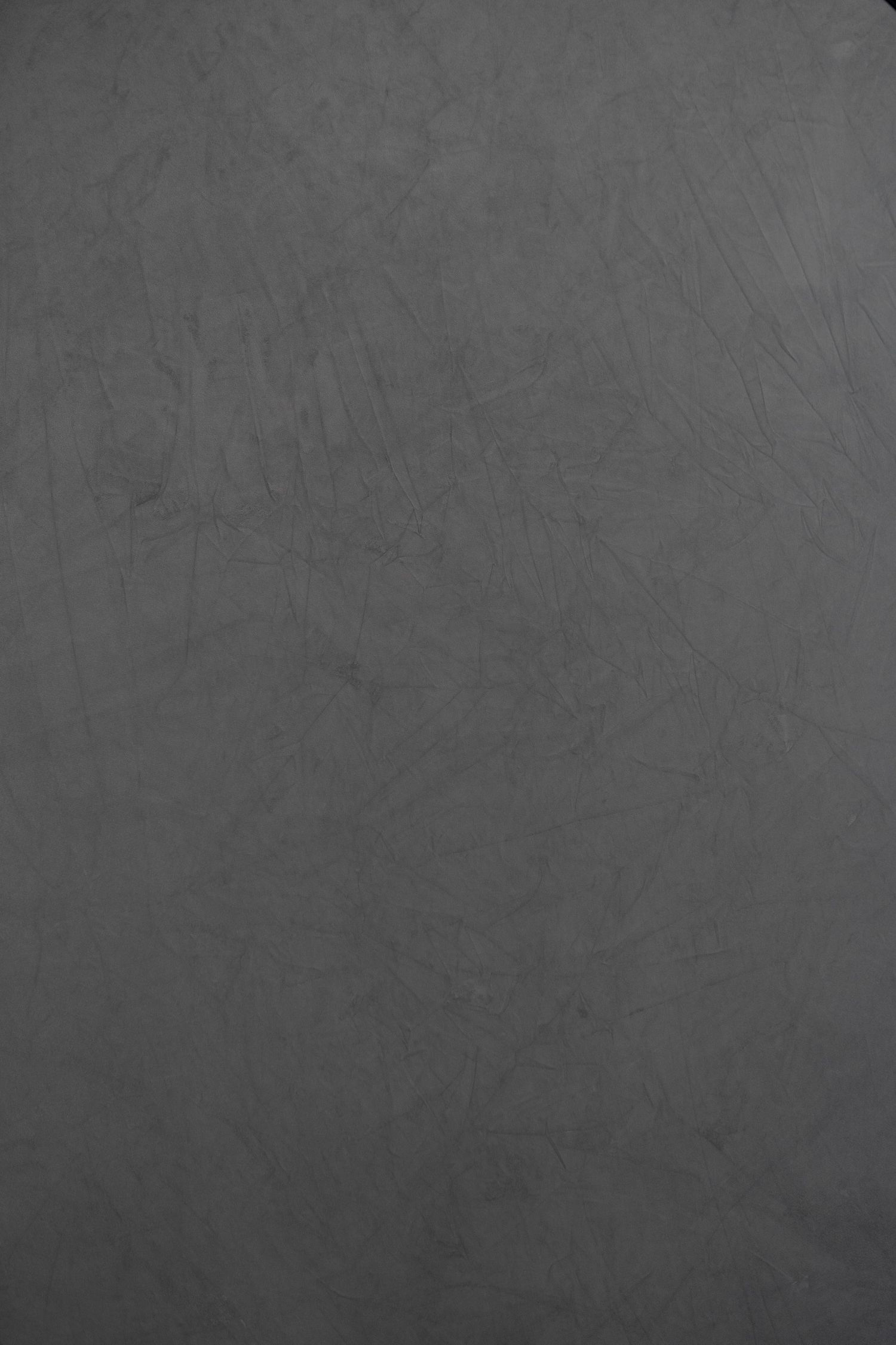 Abstract gray textured background with scratched surface pattern.