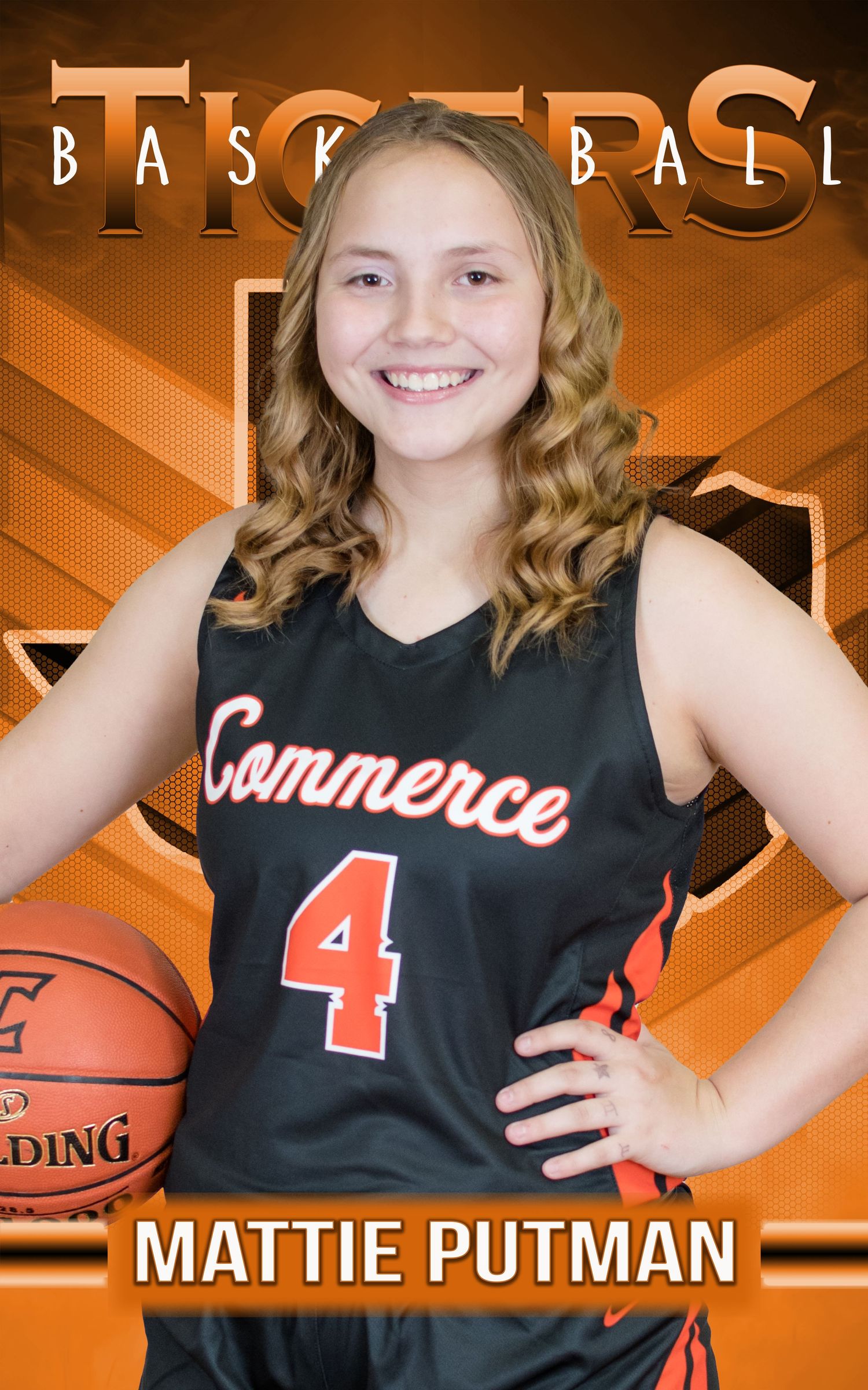 Basketball player wearing a black Commerce #4 jersey poses with a ball against an orange background.