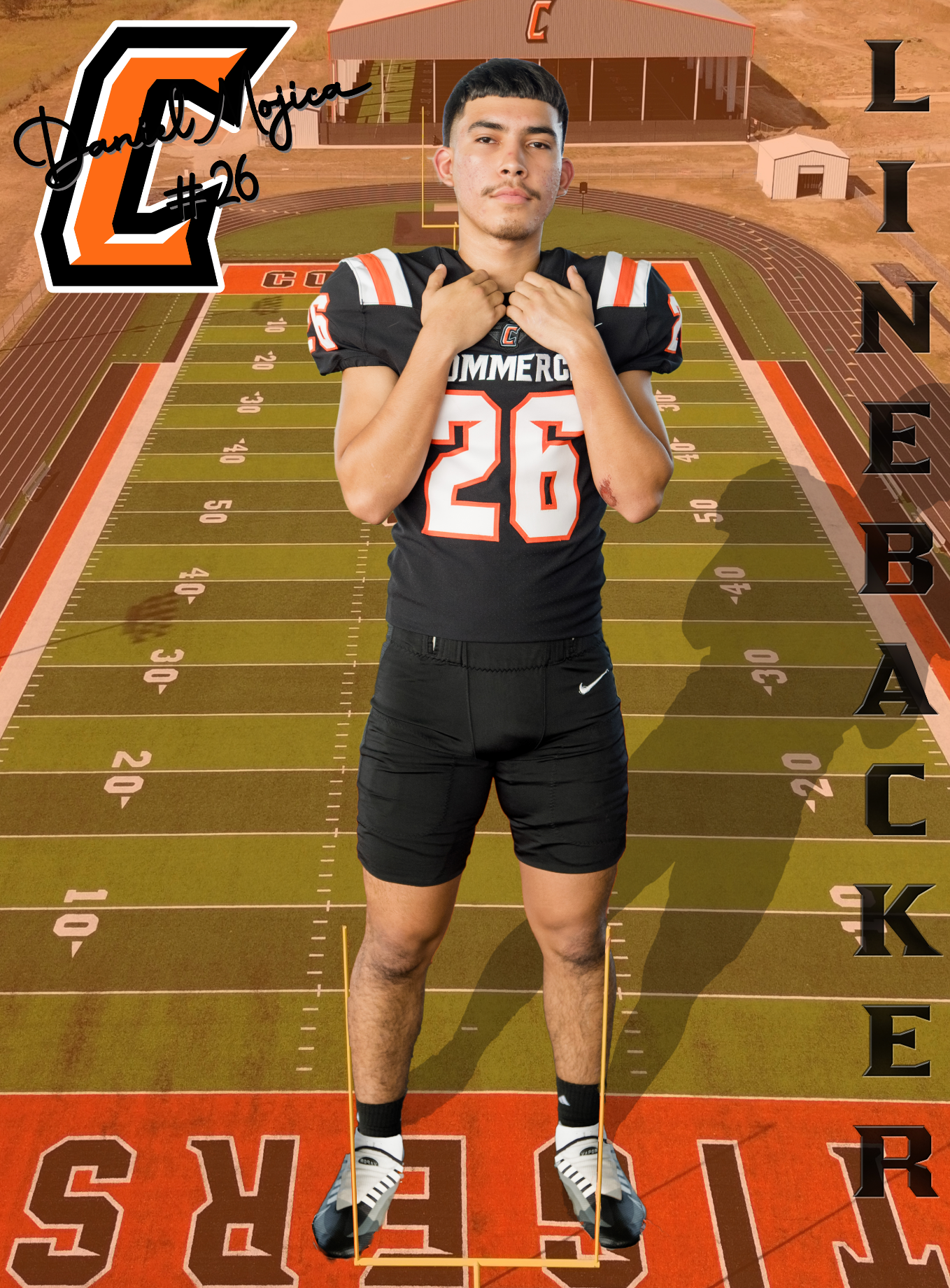 High school football player in black and orange uniform number 26 poses on football field with stadium graphics in background.