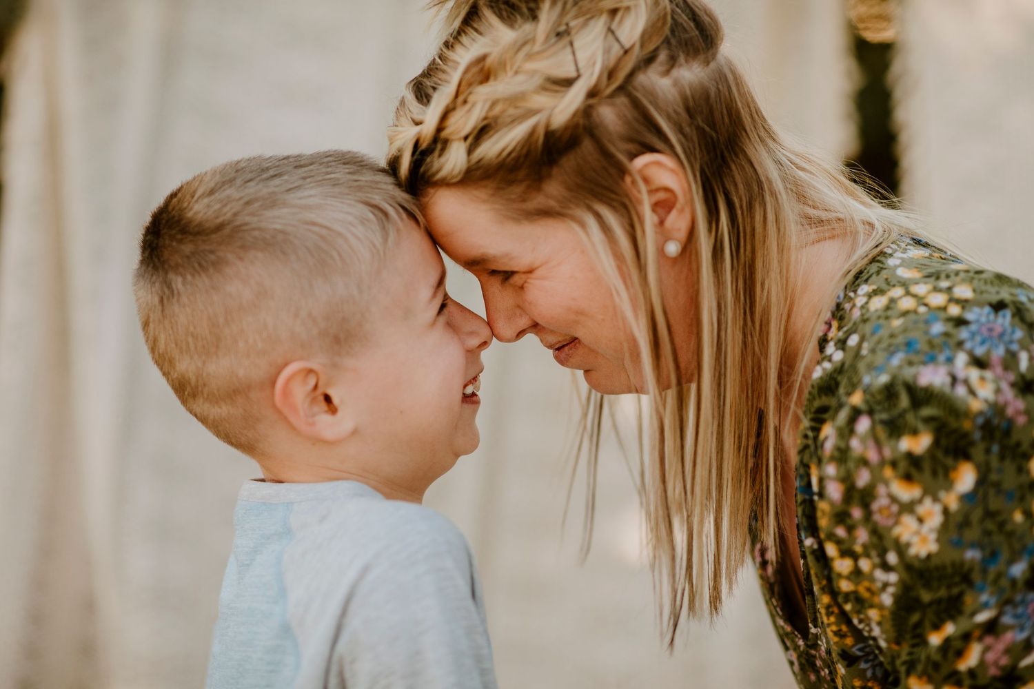 Tender moment shared between parent and child during outdoor photo session.