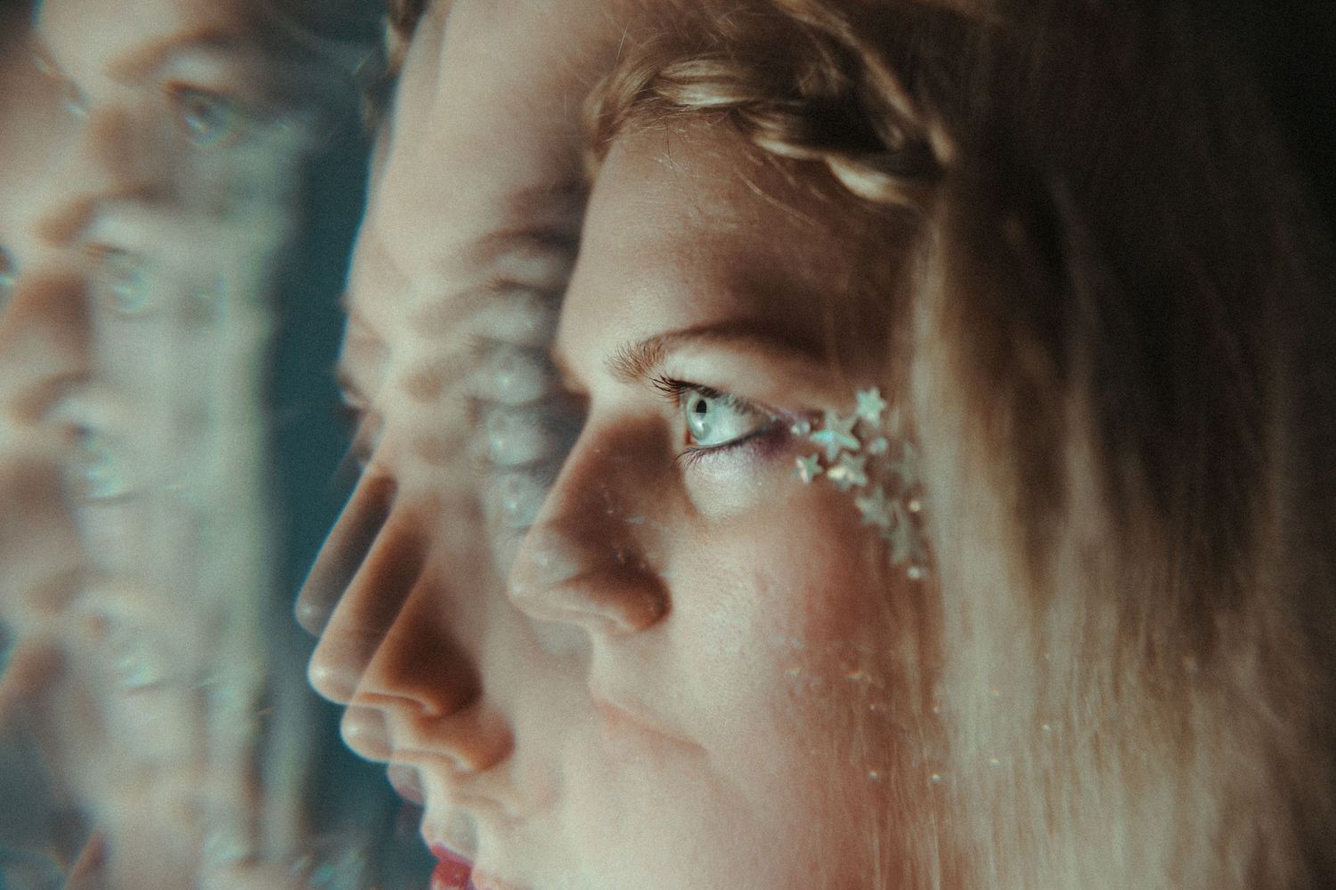 An artistic portrait with glittery effects and reflections.