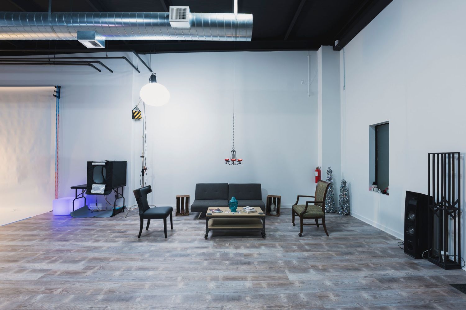 Empty industrial style room with furniture and exposed ductwork.