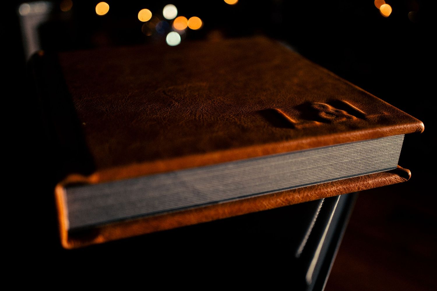 Wooden piano keys illuminated by soft bokeh lights create an artistic composition.