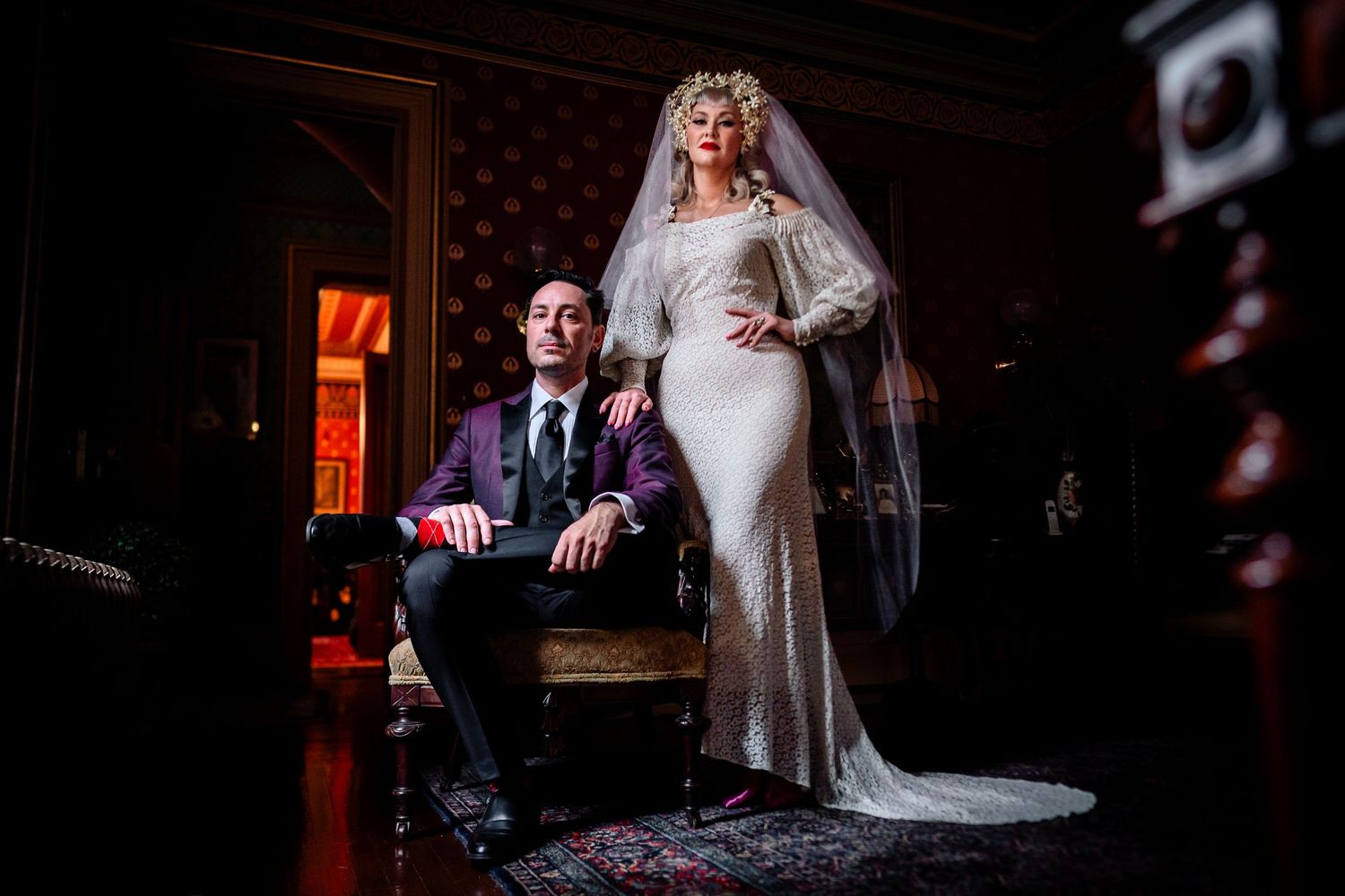 Artistic wedding portraits in dark moody lighting with dramatic shadows.