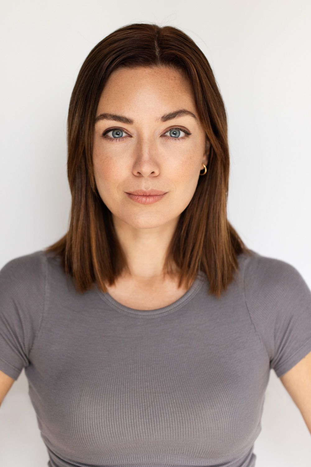 Portrait series of a person in a gray t-shirt against a white background showing different angles and expressions.