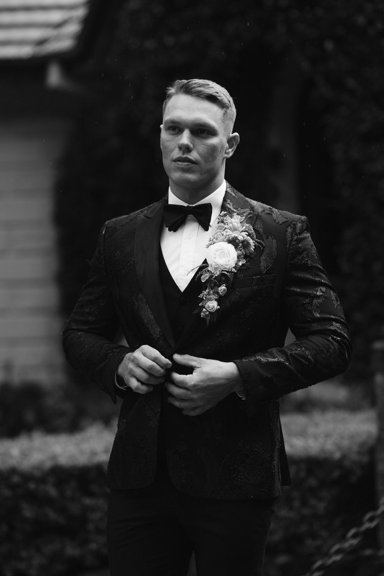A sequence of black and white formal portraits showing someone in a dark suit with a boutonniere.
