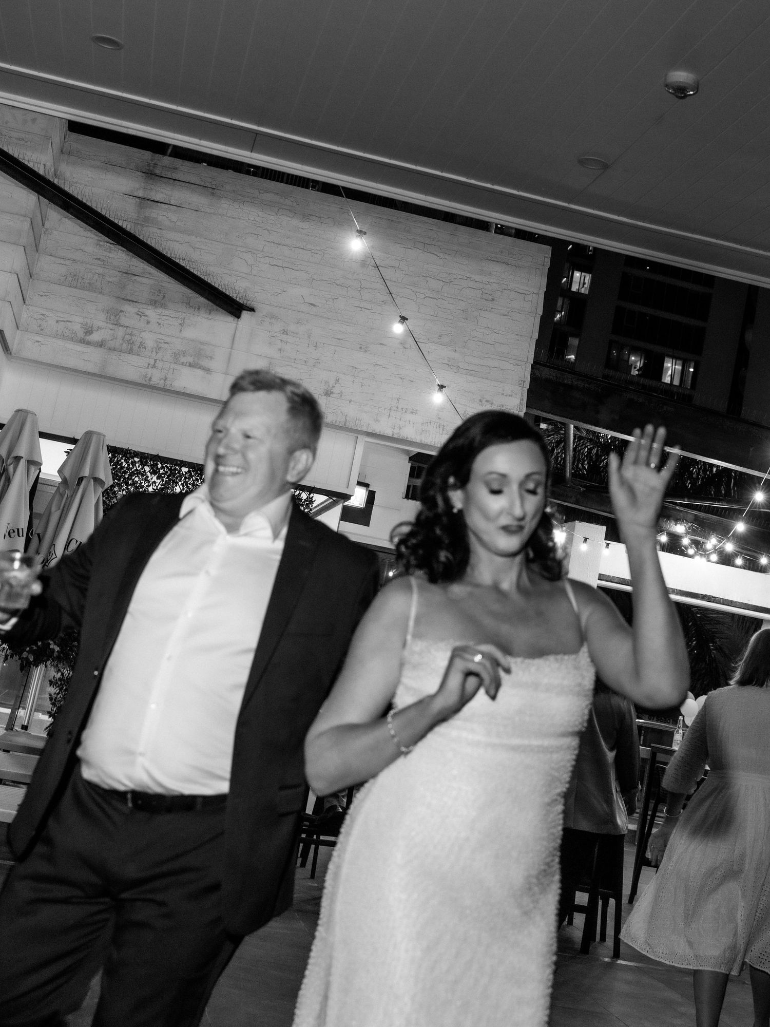 Black and white candid dance party photos showing movement and celebration.