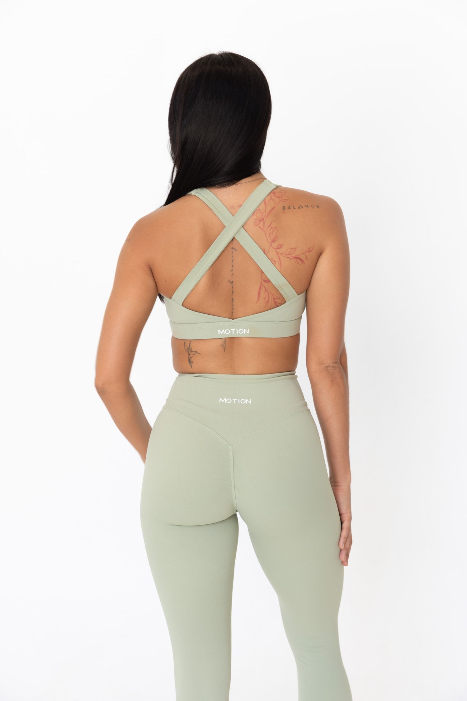 Mint green athletic wear with cross-back design shown from multiple rear angles.