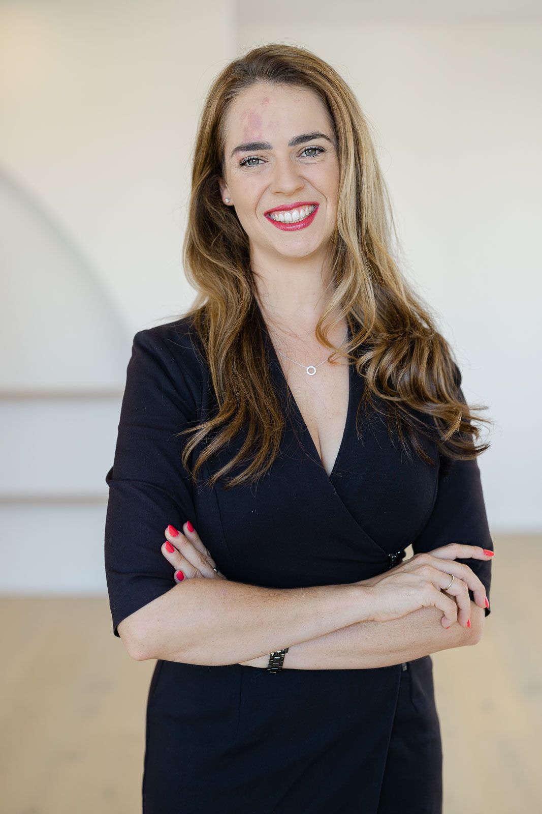 Professional portrait series showing a person in a black blazer with confident poses against a light neutral background.