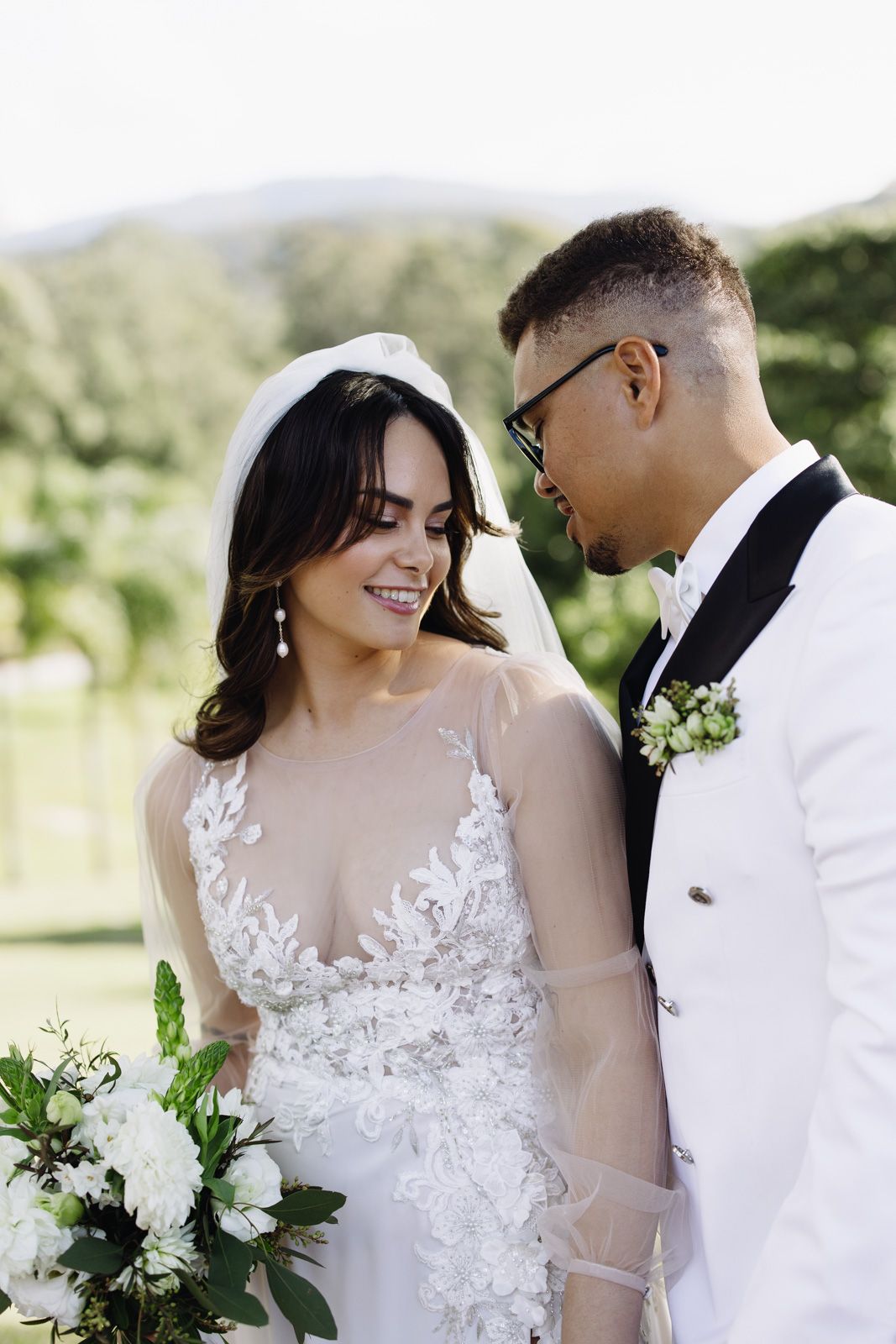 Austinvilla Estate wedding photograA romantic wedding photo collage showing a couple in white attire embracing outdoors with floral details.