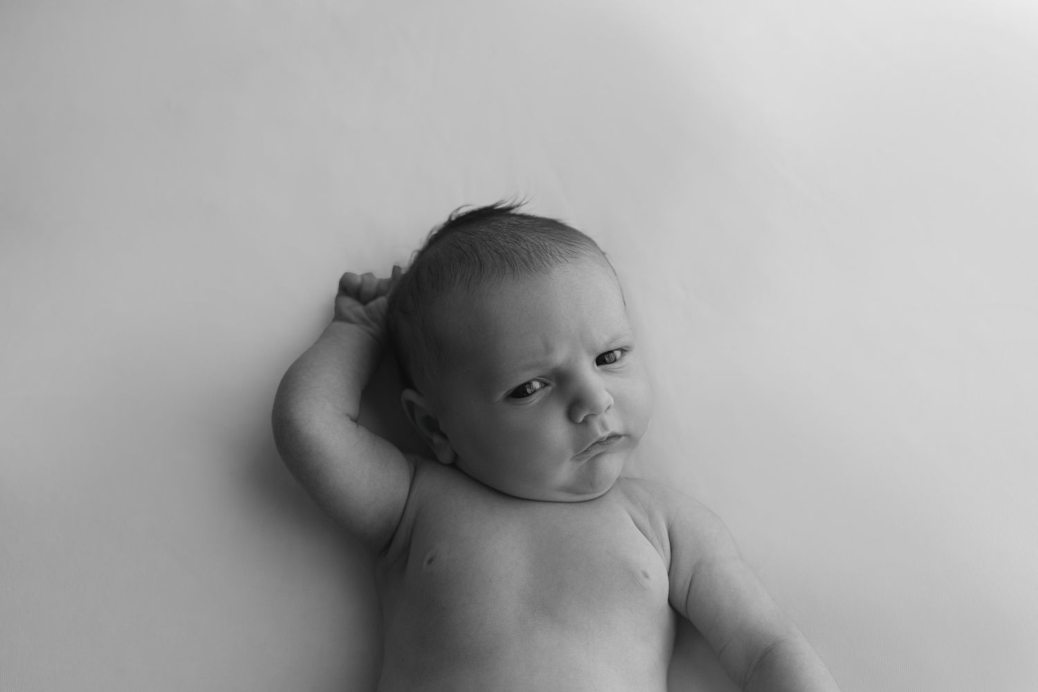 A series of black and white artistic portraits showing different angles and poses against a light background.