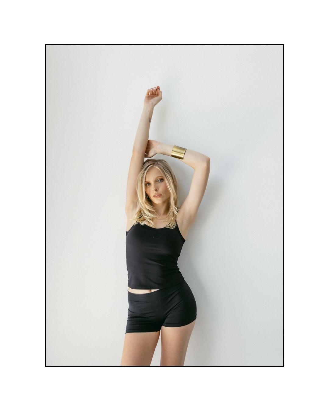 A person in black athletic wear poses against a white background in three similar studio shots.