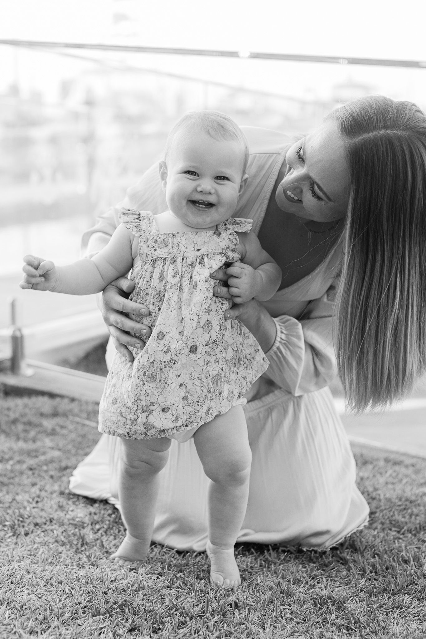 Mother and baby playing together on grass in a series of candid outdoor moments.