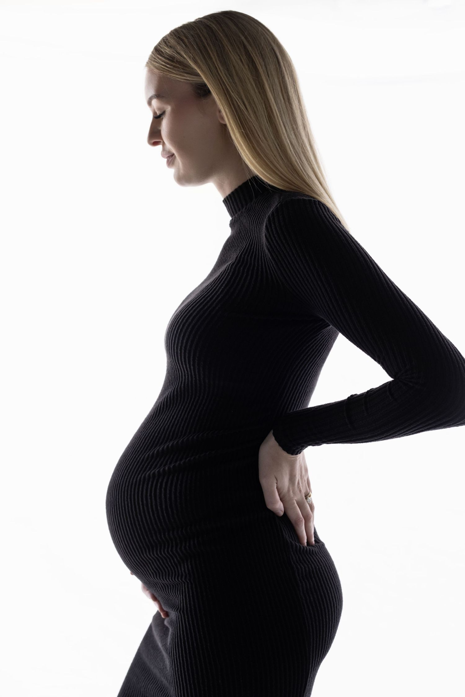 Minimalist black and white maternity photos in fitted black turtleneck.
