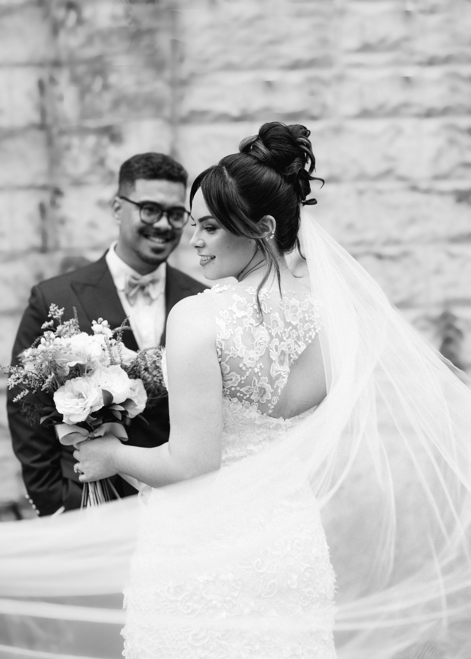 Black and white wedding photo collage showing candid moments between newlyweds with flowing veil and floral bouquet.