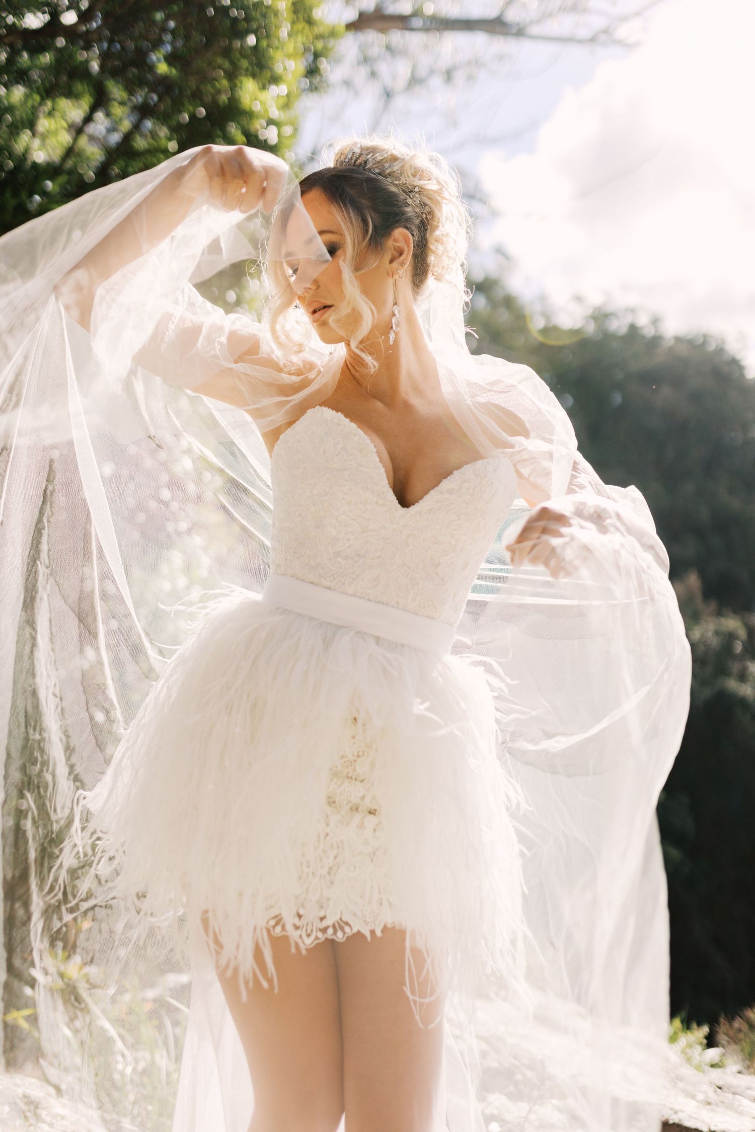 Ethereal bridal photography series featuring delicate lace and flowing veil in natural sunlight.