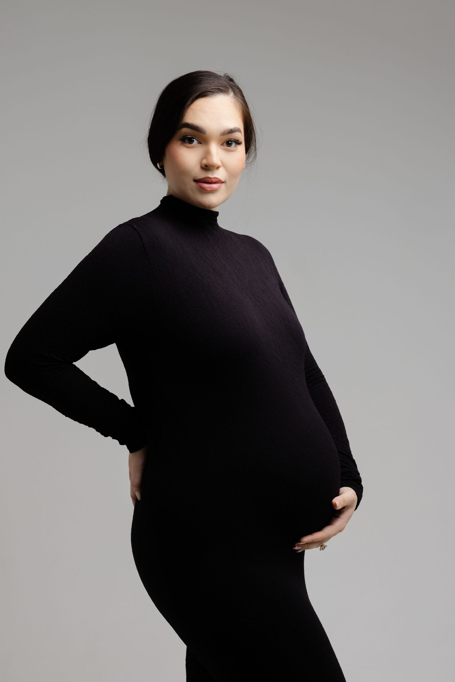 Series of elegant maternity poses in black turtleneck against light grey background.