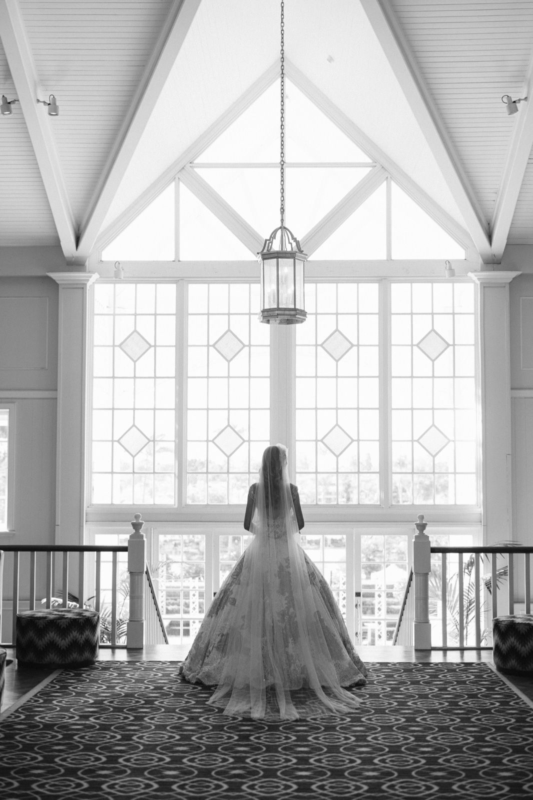 A sequence of black and white photos showing a bride in a wedding dress silhouetted against large church windows.