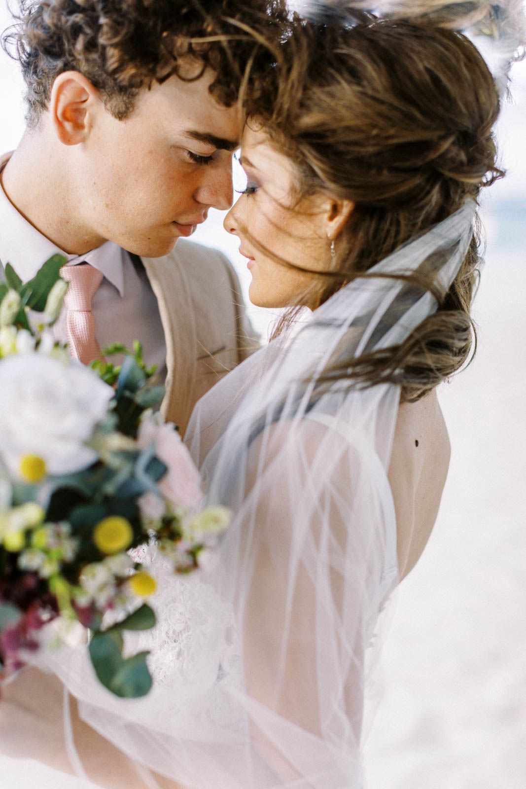 Romantic wedding photo sequence showing tender moments between couple with floral decorations in soft lighting.