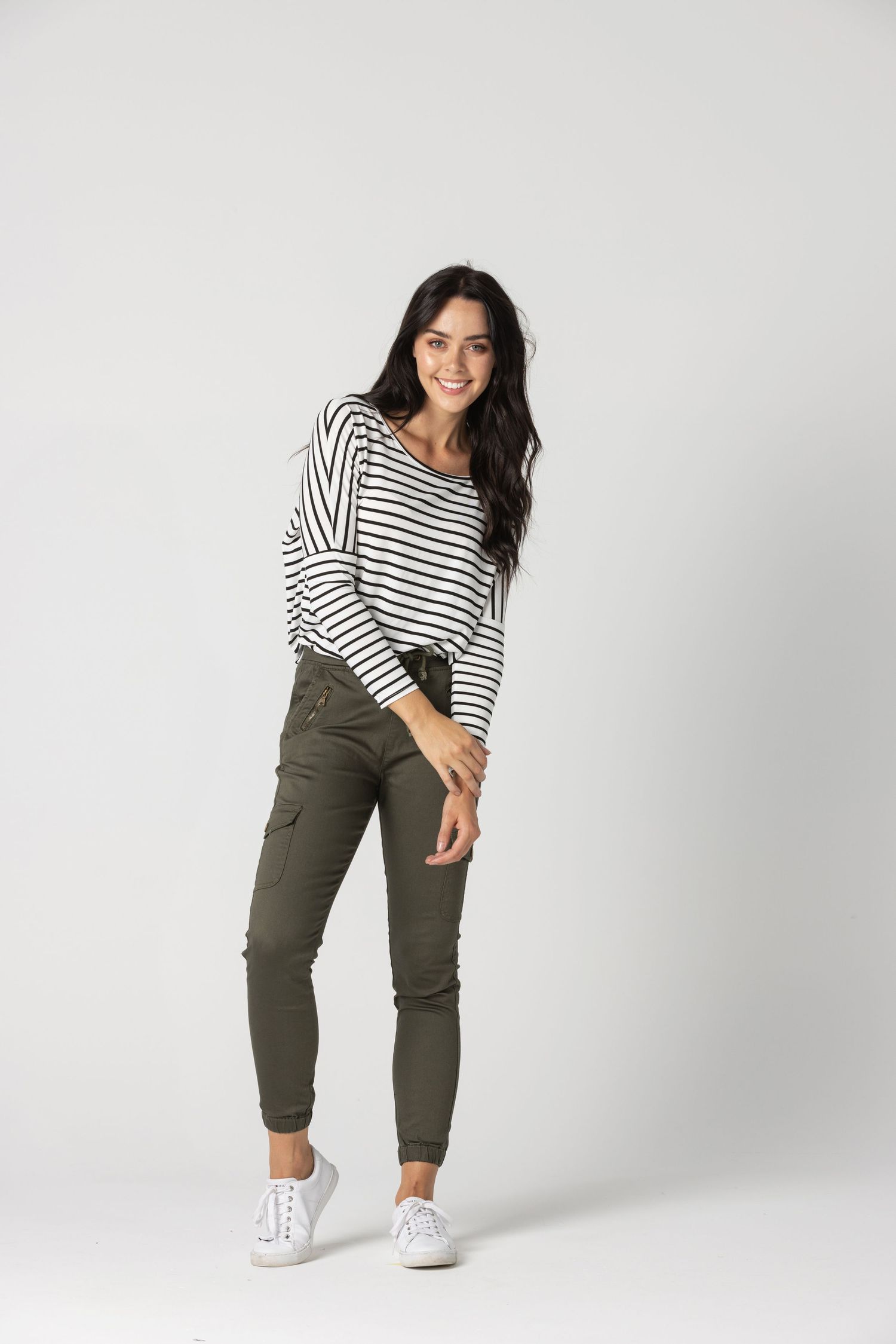 Casual outfit featuring striped top and olive joggers paired with white sneakers.