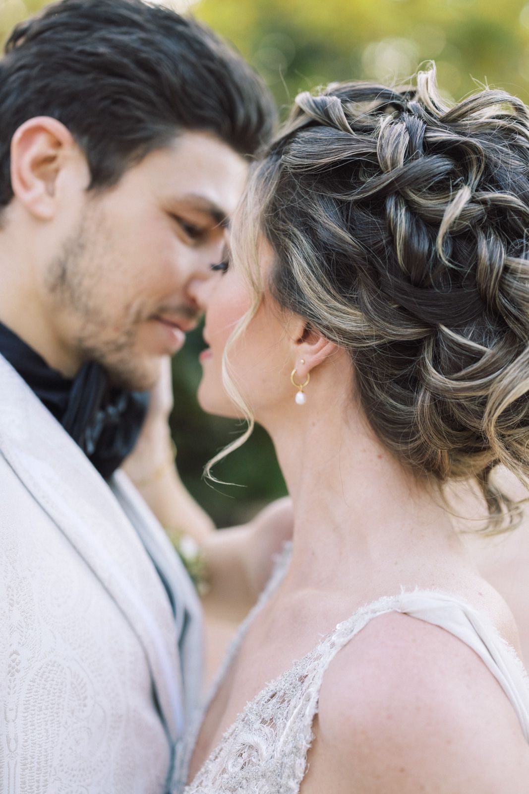 Romantic wedding portrait showing a couple in an intimate moment with soft natural lighting and elegant attire.