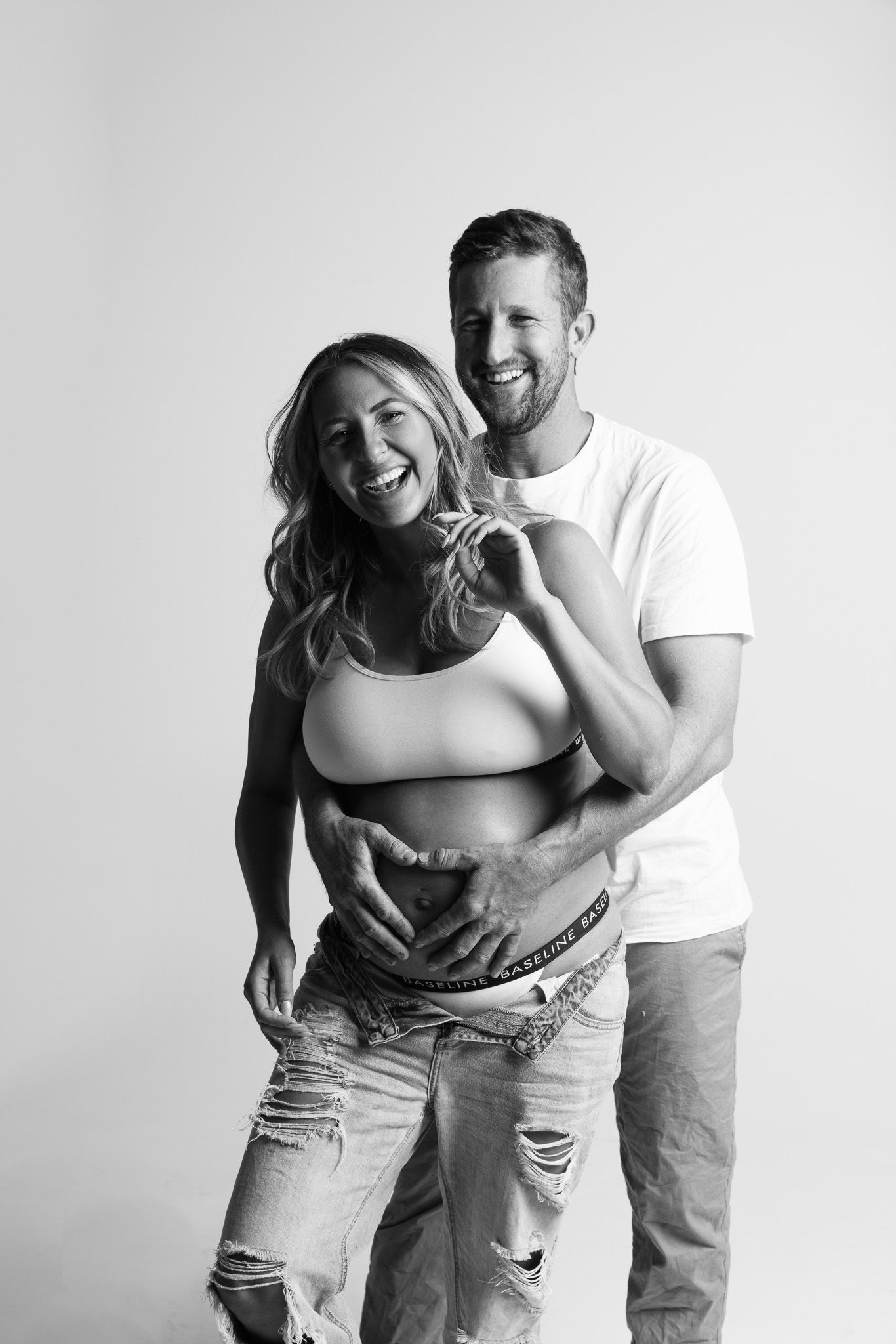 Candid black and white couple's portrait showing natural laughter and connection.