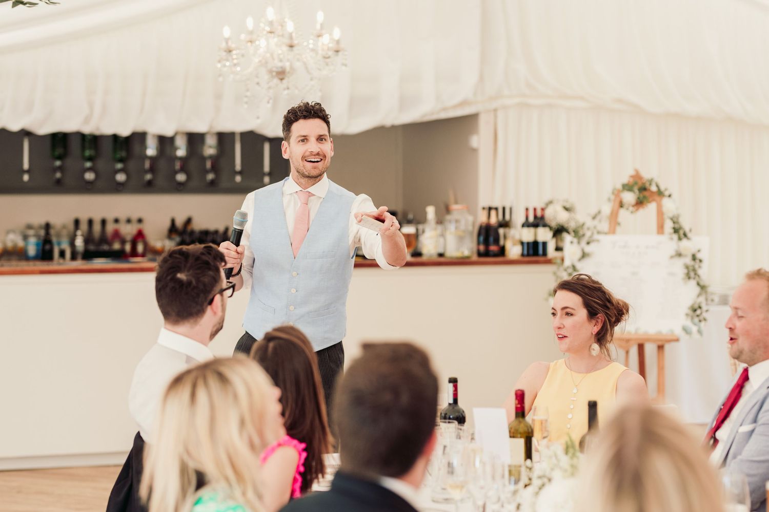 Glemham Hall Wedding Venue in Suffolk Countrysid Exchange Vows in Glemham Hall's Great HallTable Setup in Marquee with Pastel Flowers