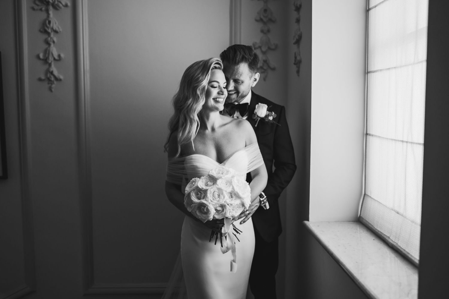 Elegant black and white wedding photography sequence in a window-lit room.