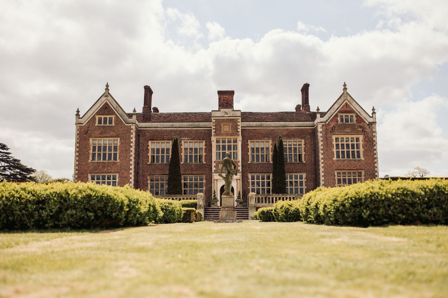 Bride and groom in North Mymms Park's elegant reception hall, perfect for timeless wedding photography.