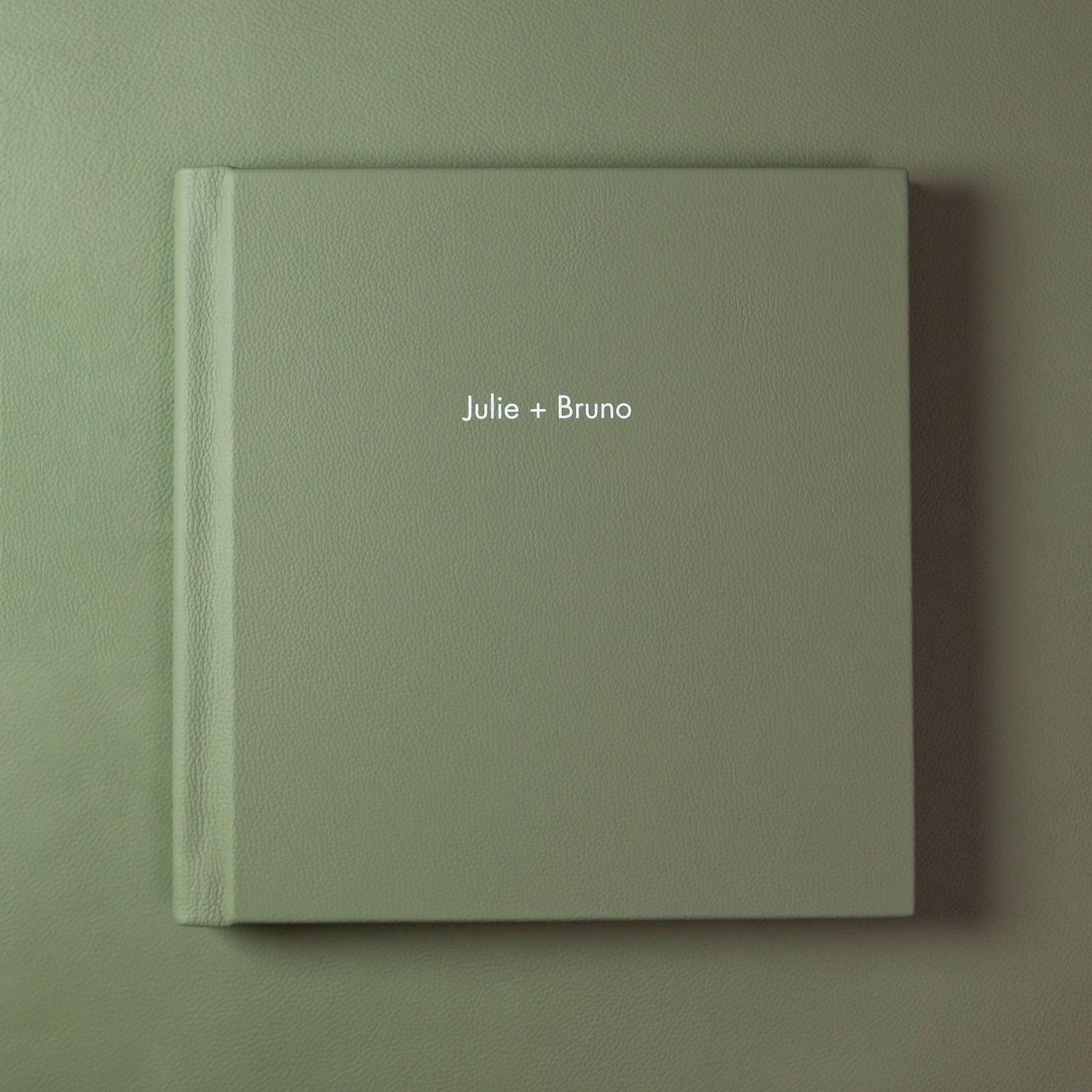 Modern light green photo album cover with subtle text placement.