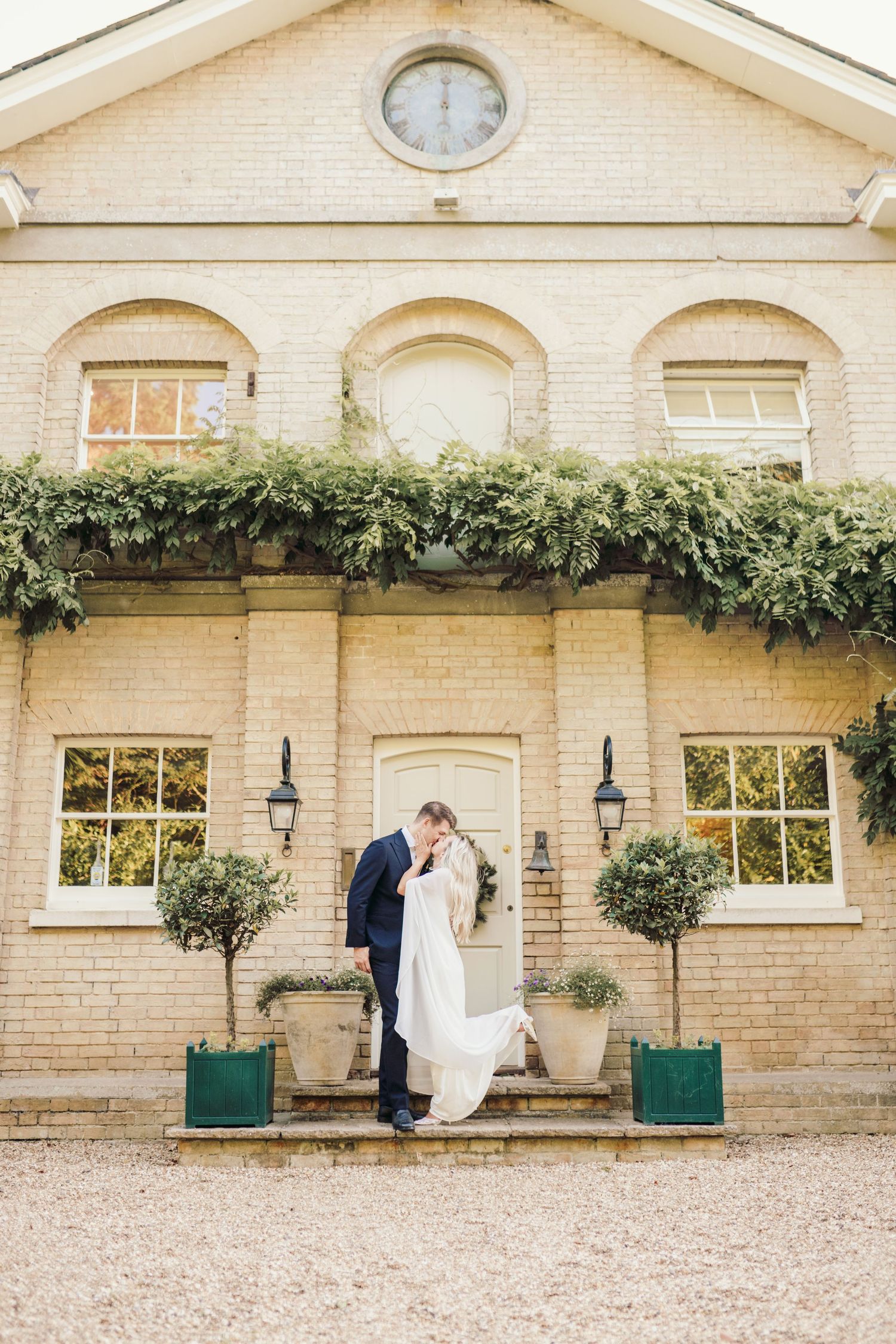 Classic brick wedding venue exterior with climbing vines and elegant architecture.