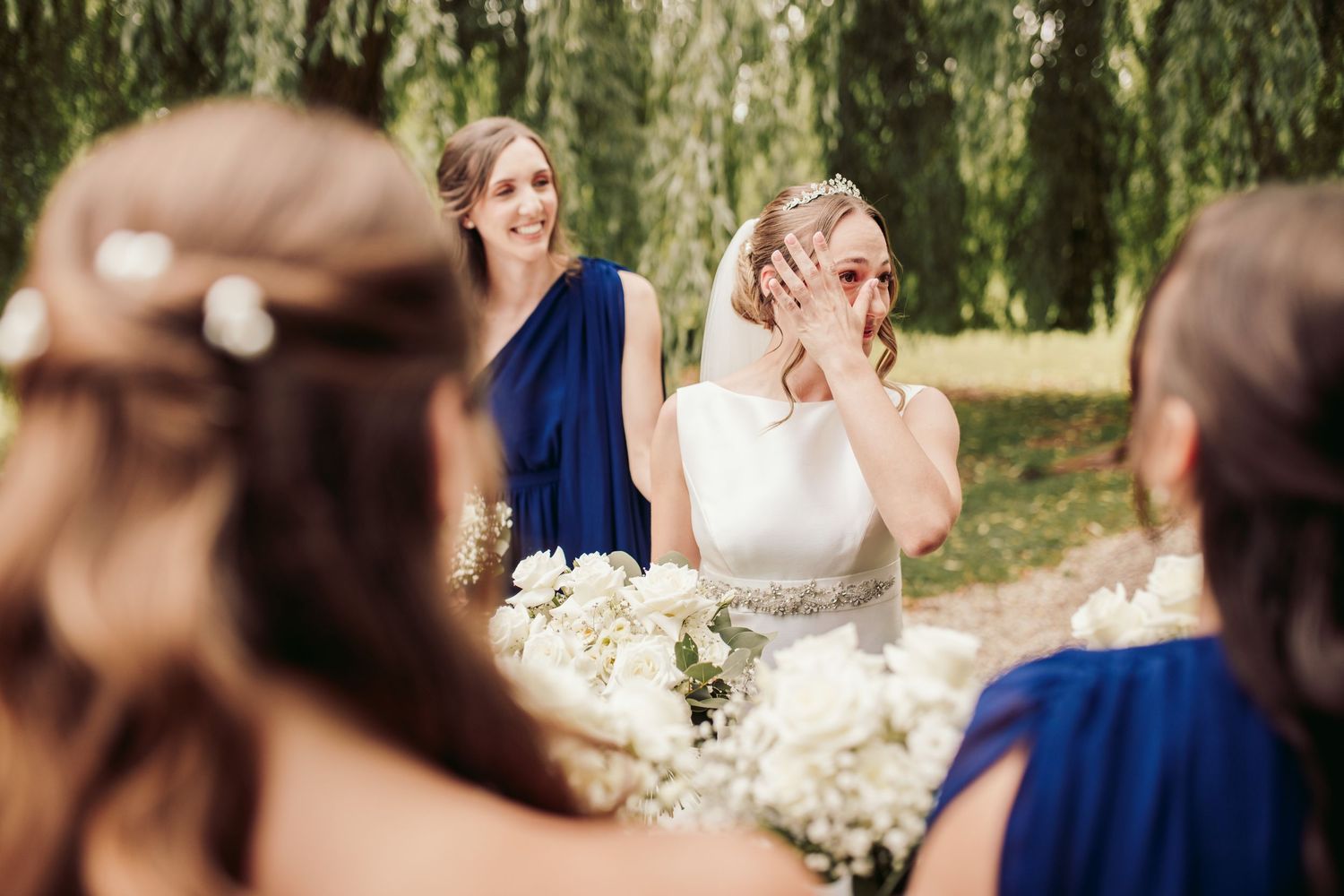 Elegant wedding celebration scene with navy blue and white color scheme in an outdoor garden setting.