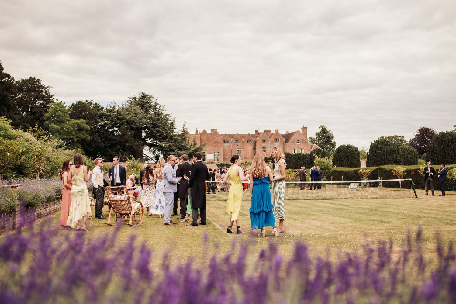 Glemham Hall Wedding Venue in Suffolk Countrysid Exchange Vows in Glemham Hall's Great HallTable Setup in Marquee with Pastel Flowers