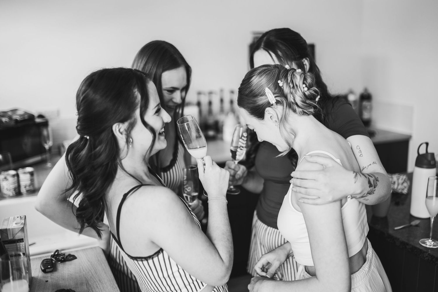 A series of black and white candid photos showing emotional reactions and embraces at a social gathering.