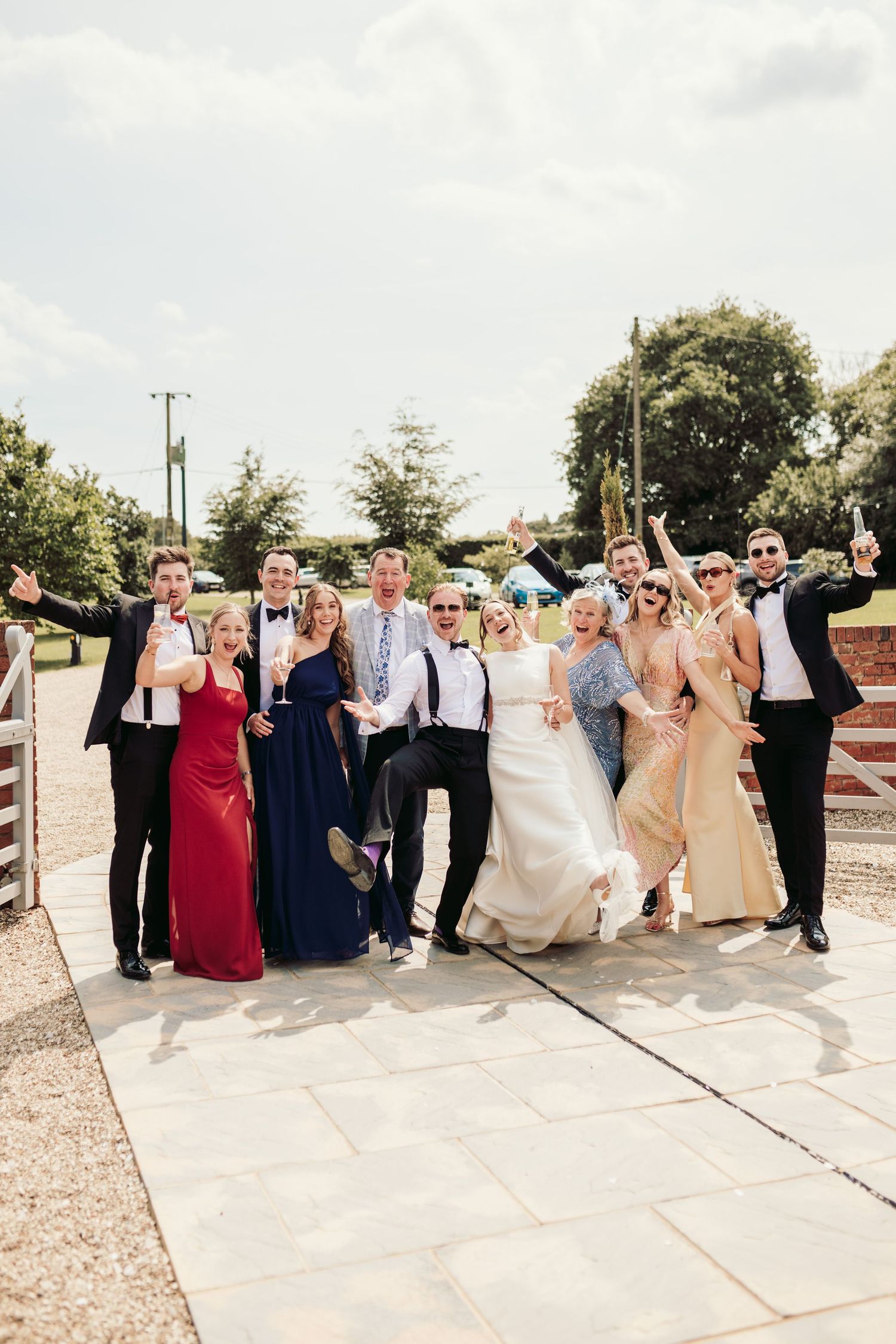 A wedding party poses together on a patio in a sequence of four candid celebration photos.