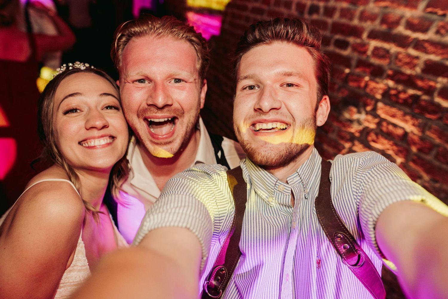 Wedding reception party photos with pink and purple lighting effects.