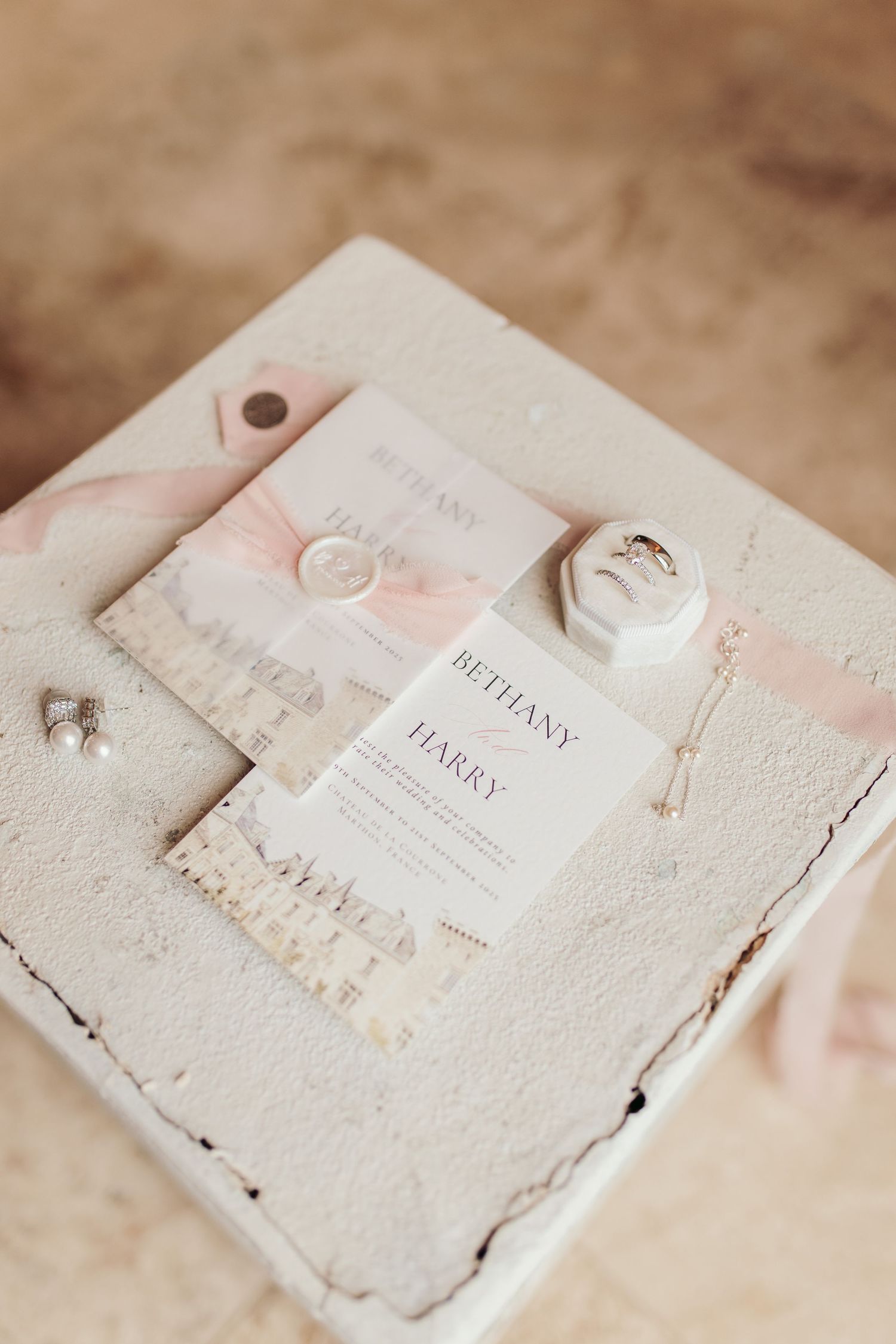 Handcrafted wedding invitations with delicate pink watercolor details.