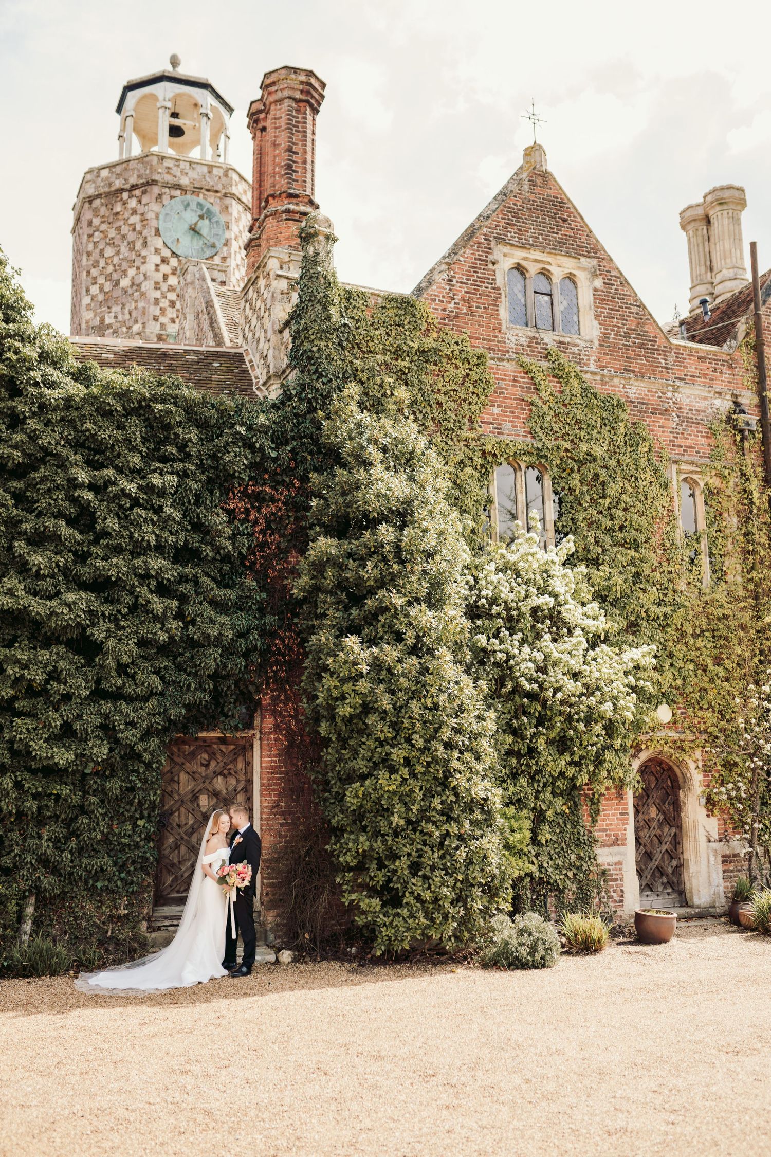 Elegant wedding photos at historic ivy-covered estate with brick architecture.