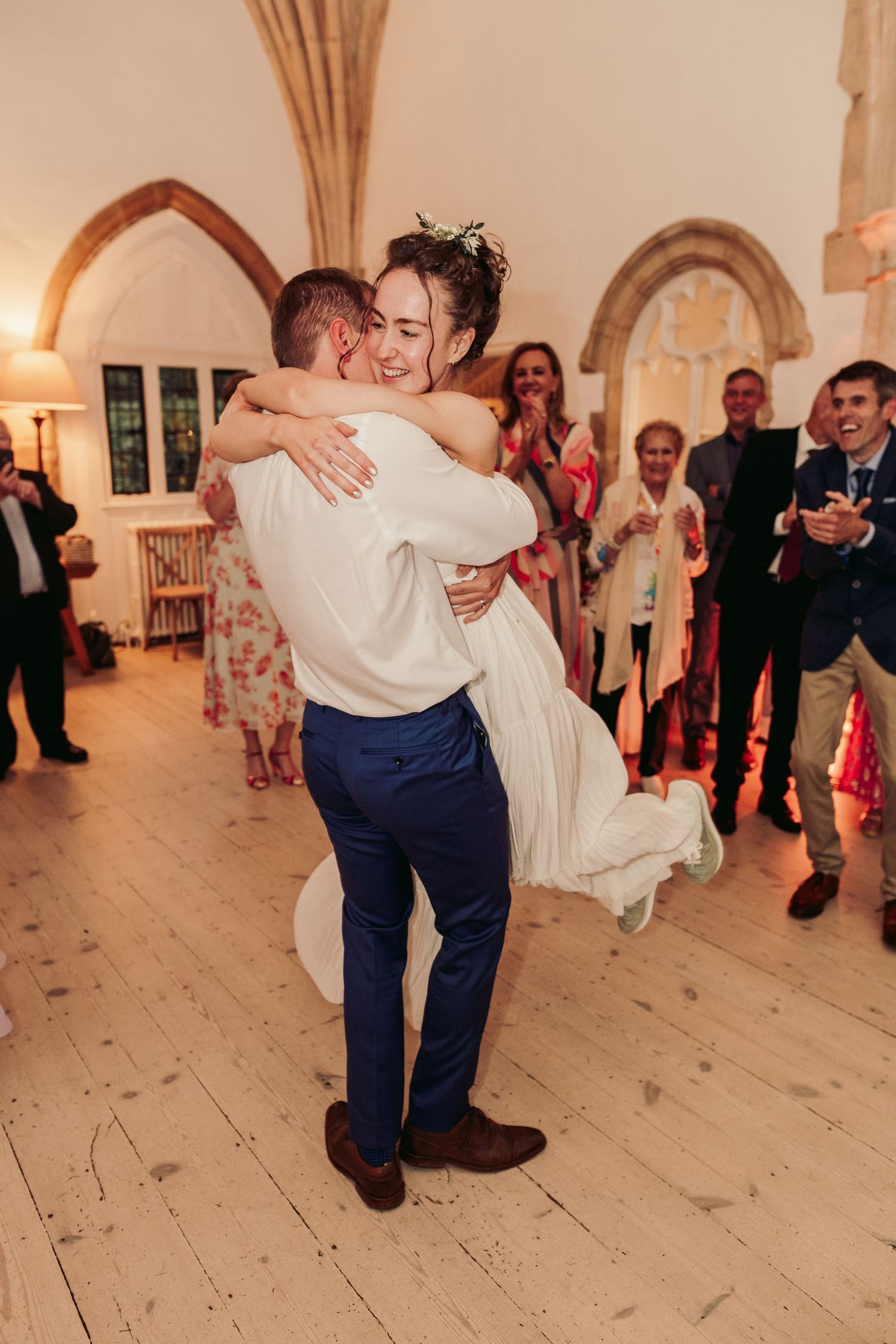 A romantic first dance moment in a historic church venue with vaulted ceilings.