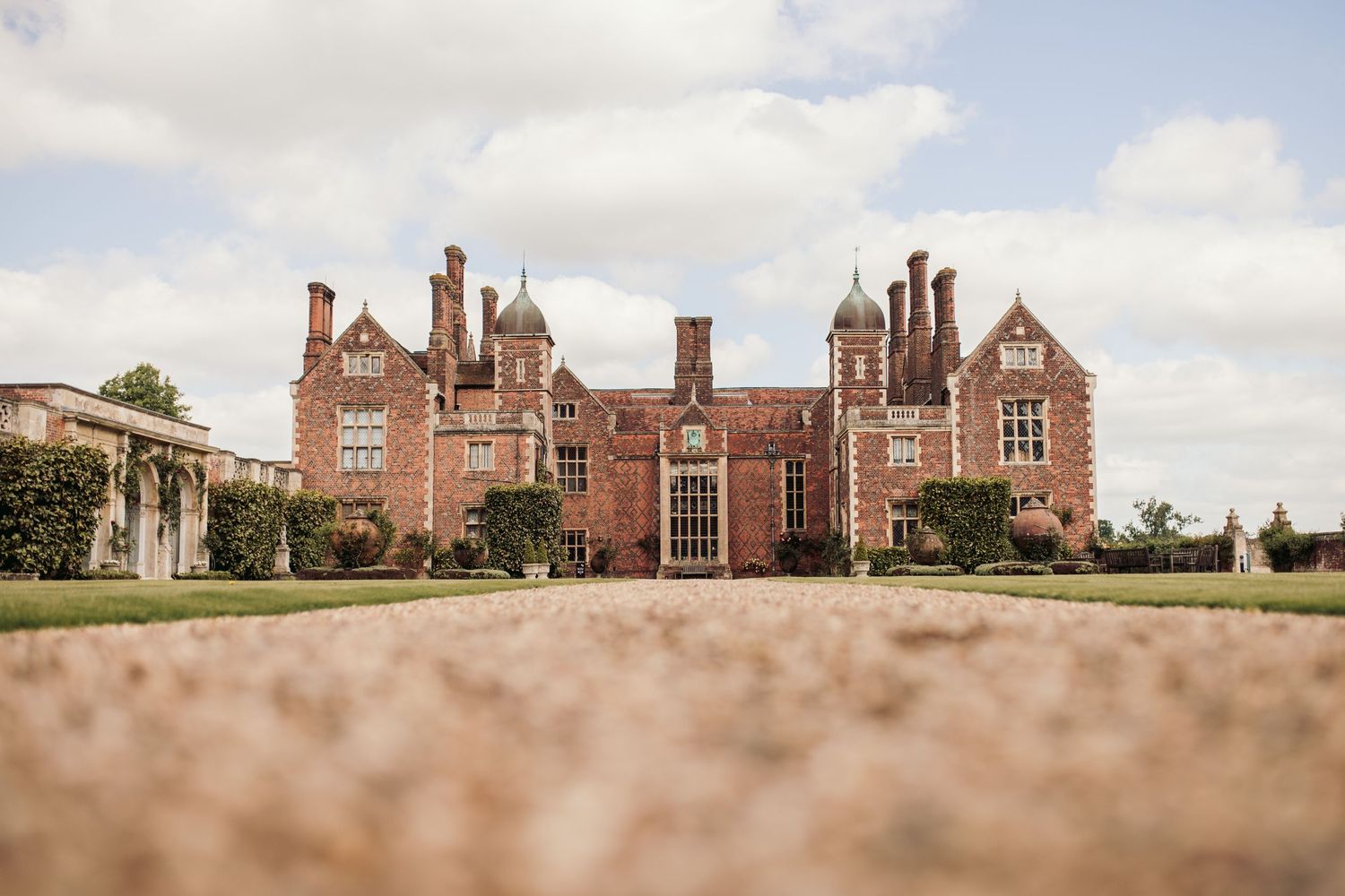 Bride and groom in North Mymms Park's elegant reception hall, perfect for timeless wedding photography.