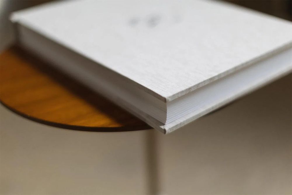Detail shot of clean white photo album pages with minimalist design.