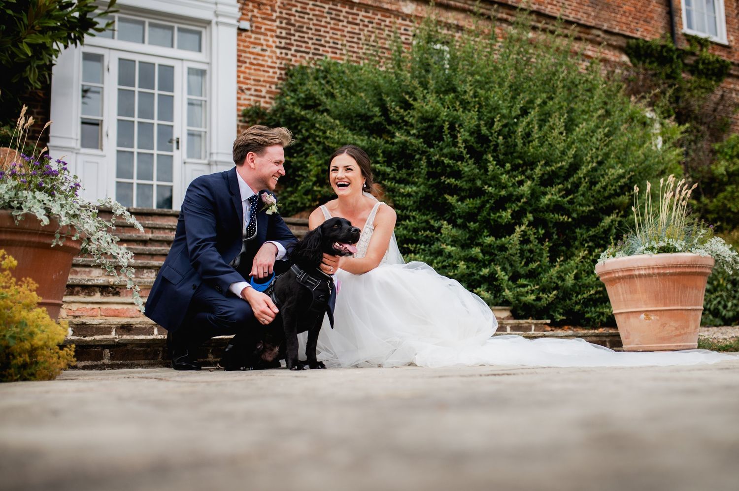 Elegant wedding venue with red brick walls and lush greenery.