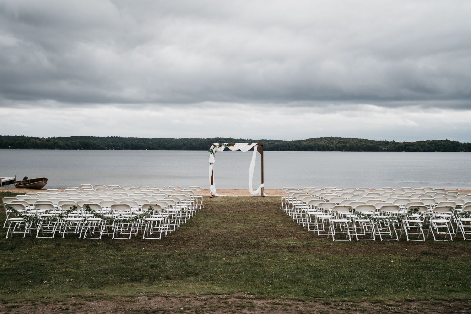 A dramatic cloudscape sets the stage for an intimate Muskoka beach wedding